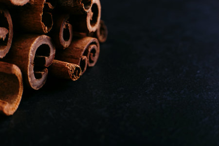 Spices sticks cinnamon on old table. Rustic background, aroma close-up.