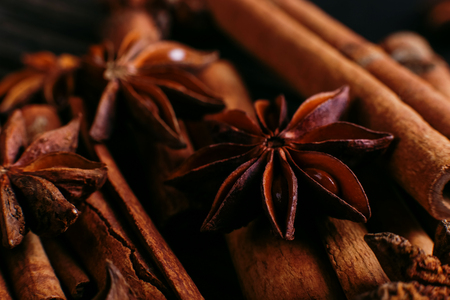 Spices sticks cinnamon and star anise on old table. Rustic dark background, aroma close-up, macro.の写真素材