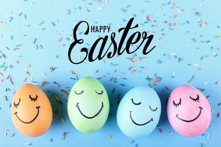 Colored eggs with painted smiles. Happy Easter, concept greeting card design.の写真素材