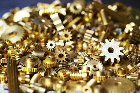 Big pile of cogwheels on a metallic surface