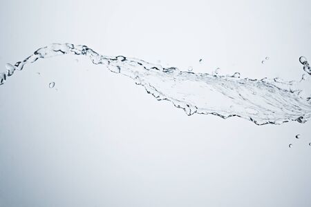 Water splash on white background with bubble trailの写真素材