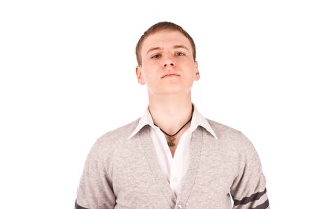 Young man posing with his shirt and cardigan on a white backgroundの写真素材