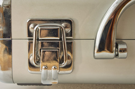 Business security concept. Close-up of a locked modern metal briefcase with a chrome latch and...