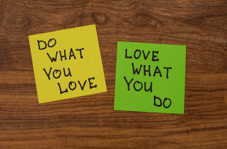 Yellow and green note paper t on rustic wooden background. 'Love What You Do and Do What You Love'...
