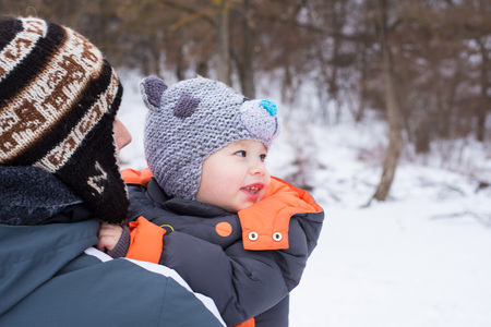 Family of father and his son outdoors on beautiful winter snowy day. Portrait of happy father and his adorable little son. Concept of friendly family. Cute boy with dad playing outdoor in winter.の写真素材