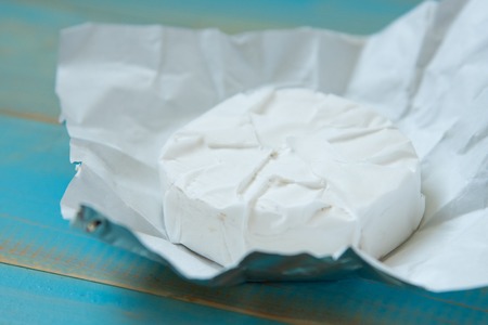 cheese camembert on the blue wooden backgroundの写真素材