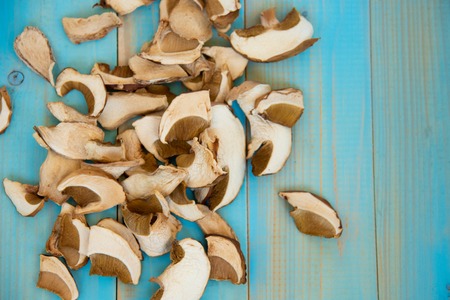 Dried mushrooms, on a blue wooden tableの写真素材