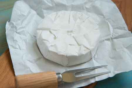 cheese camembert or brie on blue wooden backgroundの写真素材