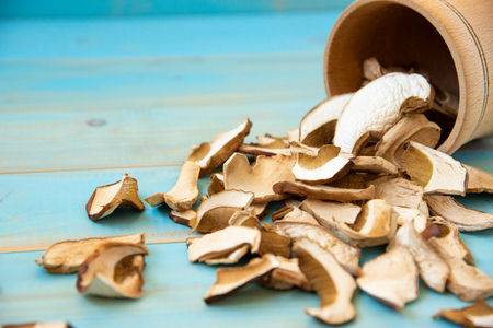 Dried porcini mushrooms on blue wooden backgroundの写真素材