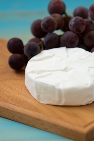camembert, with a fork for cheese and grapeの写真素材