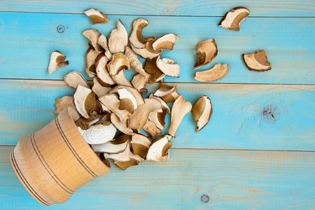 Dried mushrooms, on a blue wooden tableの写真素材