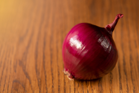 Fresh purple onion on dark wooden background.の写真素材