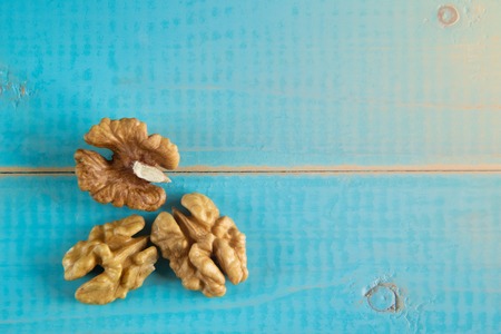 Walnut kernels on a blue wooden background.の写真素材