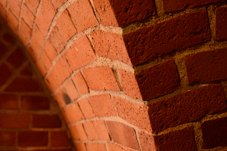 Old red brick wall with an arc backgroundの写真素材