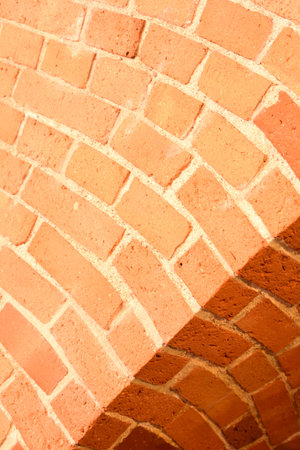 Old red brick wall with an arc background