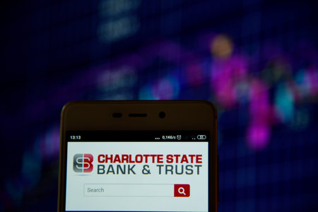 Sharlotte State Bank Trust logo on smartphone