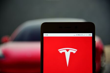 Tesla logo seen on the smartphone closeupのeditorial素材