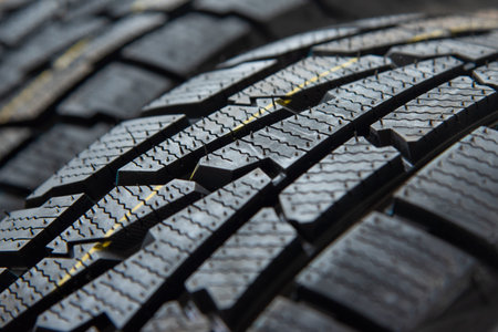 Protector close-up of new winter tires. on black background