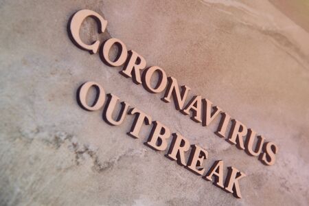coronavirus outbreak word written on wooden letters.の写真素材