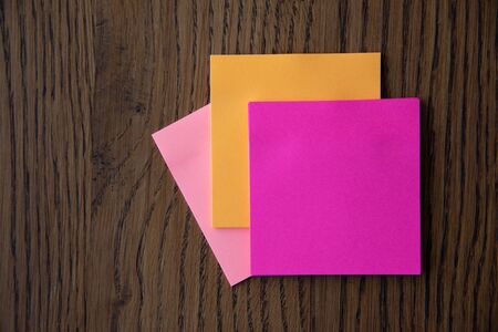 Colorful sticky notes on wooden background image.の写真素材