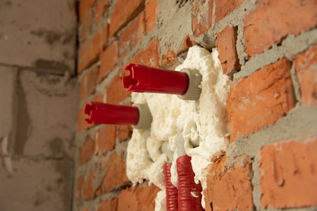 Pipes in isolation are fixed by mounting foam
