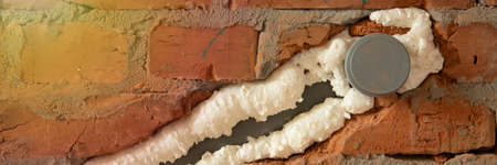Pipes in isolation are fixed by mounting foamの写真素材