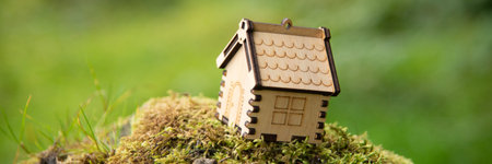 Wooden house model in a forest Eco house concept