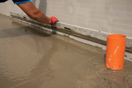 Mason leveling and screeding concrete floor baseの写真素材