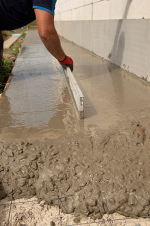 Mason leveling and screeding concrete floor baseの写真素材