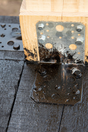 Applying a bituminous primer to the wooden frame of the terrace. Waterproofing of wooden bars and...