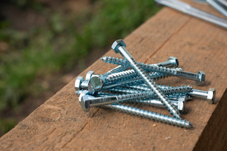 Timber screws . Fasteners for timber frames. Self-tapping screws, screws on a wooden beam.の写真素材