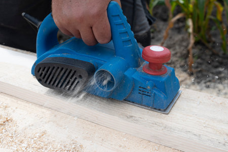 Worker is planing boards