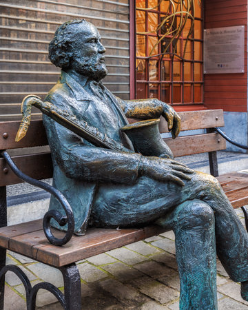 Statue of Adolphe Sax on a bench in the old town of Dinant, Belgiumのeditorial素材