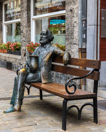 Sculpture of Statue of Adolphe Sax on a bench in the old town of Dinant, Belgiumのeditorial素材