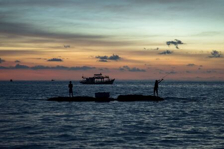Fishermen catch fish during a beautiful sunset. Phu Quoc island. Vietnam.の写真素材