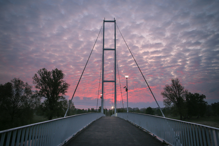 White bridge over the river at sunriseの写真素材
