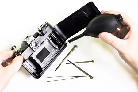 Cleaning of old  black camera using air bulb