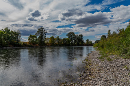 The Santiam River in Oregon with a blue sky with clouds.