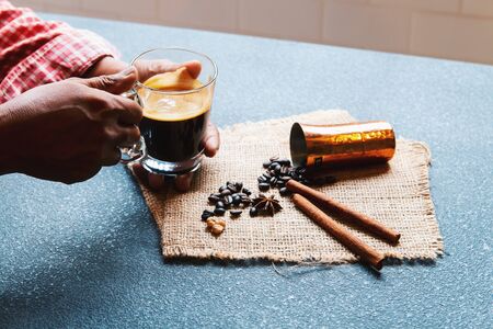Cropped shot of man holding a cup of coffee in the morning with ingredients. Hipster lifestyle, Travel inspiration, Cafe shop.の写真素材