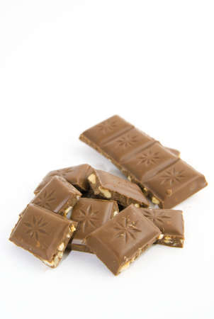 Milk chocolate with nuts on white backgroundの写真素材