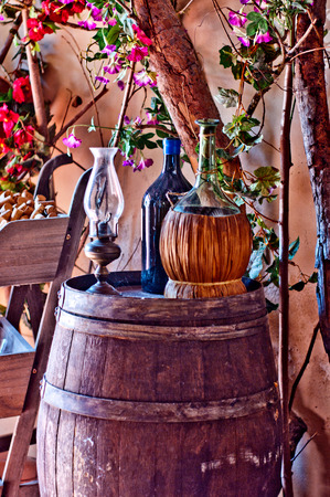 wine bottles, with bottle of olive oil, resting on an oak barrel cellar in a typical Italianの写真素材