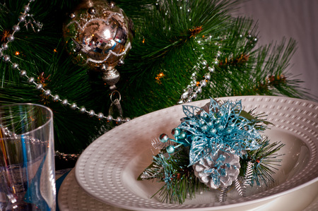 table set for christmas dinner with decoration blue and silver with Christmas tree and set the mood for Christmasの写真素材