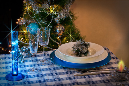 table set for christmas dinner with decoration blue and silver with Christmas tree and set the mood for Christmasの写真素材