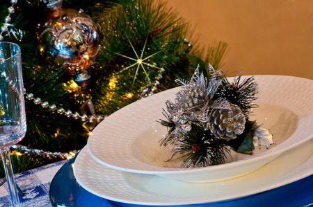 table set for christmas dinner with decoration blue and silver with Christmas tree and set the mood for Christmasの写真素材
