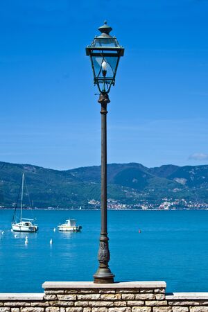 lamppost with light bulb on the waterfrontの写真素材