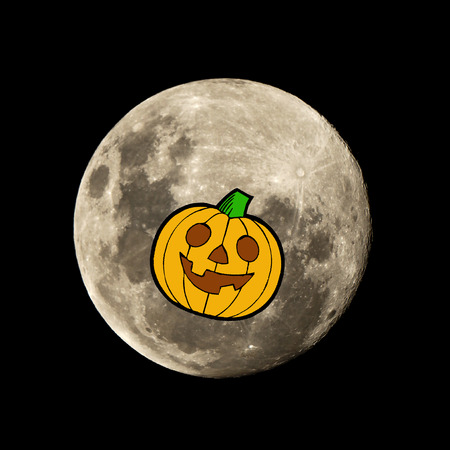 hallowen pumpkin in the dark night is set against the silhouette of the moonの写真素材