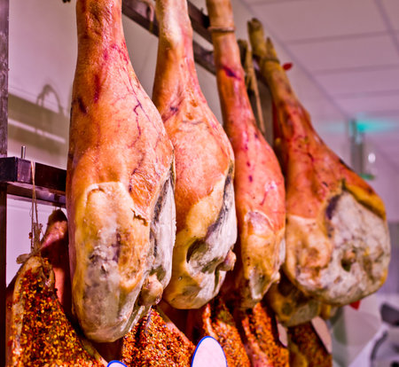 hams hanging just out of the period of the traditional seasoning with spices, salt, pepper and hot...