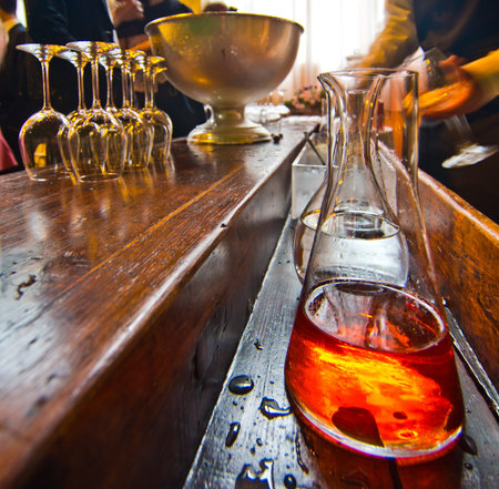 old bar with bottle of high-quality spirits and liqueur glasses ready to be filled