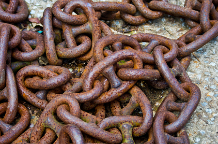 old rusty iron chains, knotted and worn from useの写真素材