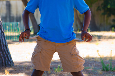 Poverty in the empty pockets of a young black manの写真素材